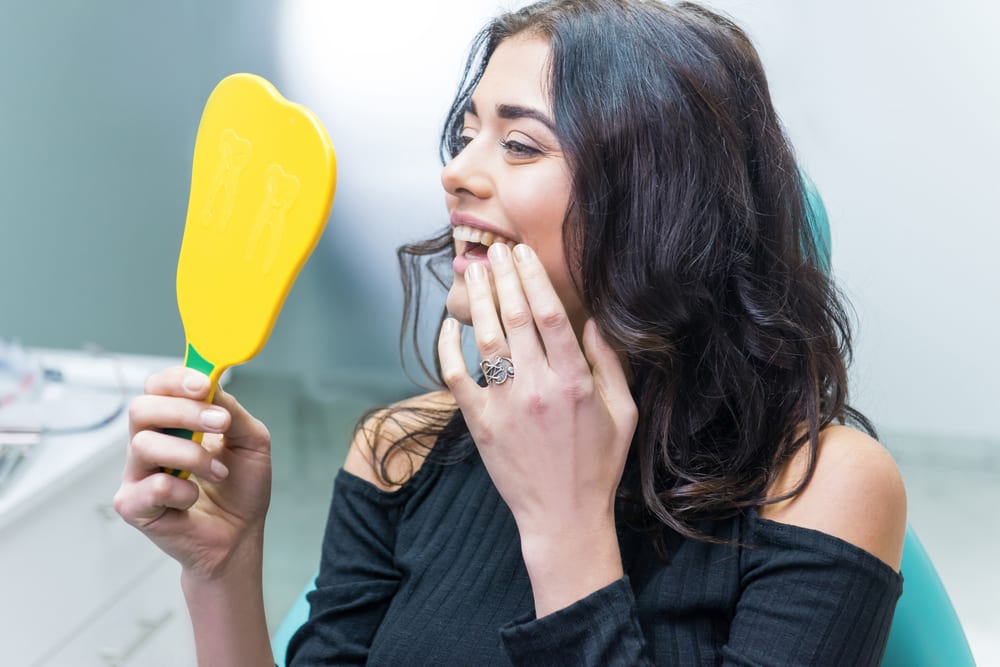 young woman admiring her white teeth