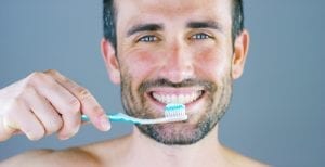 Man Smiling With Toothbrush